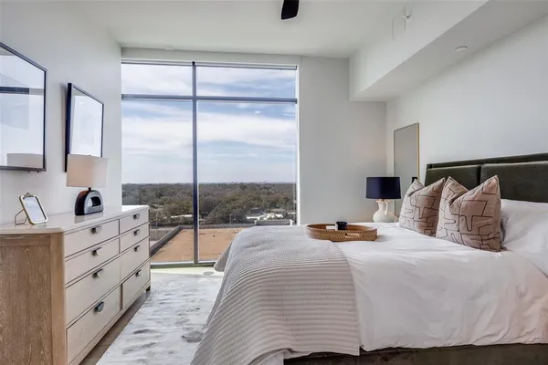 a bedroom with double bed and a dresser
