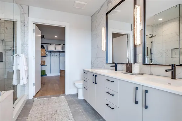 a spacious bathroom with a double vanity sink mirror and