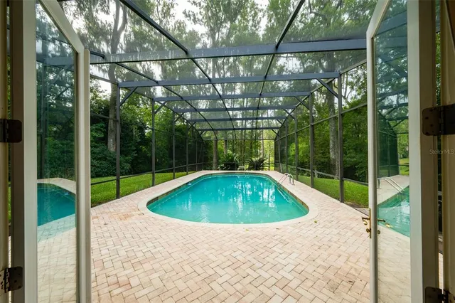 a view of a dining room with furniture and a floor to ceiling window