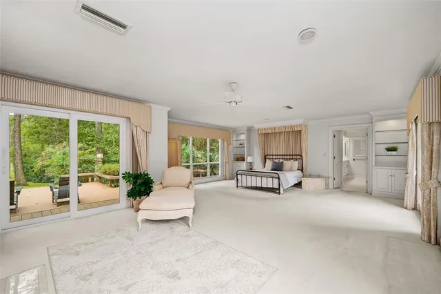 a spacious bedroom with a large bed and a large window