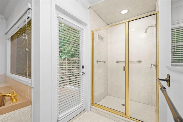 a bathroom with a tub a sink and a mirror