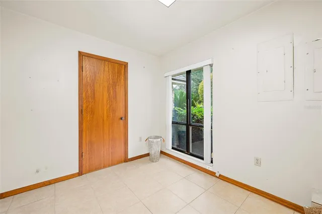an empty room with window and a ceiling fan
