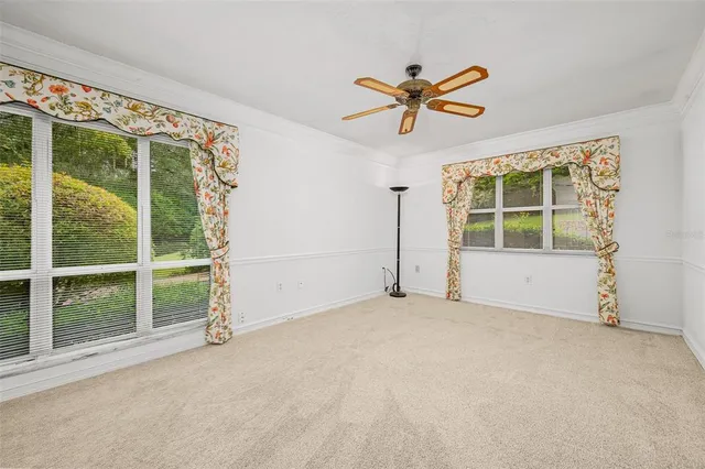 a view of a garden with a bench in front of the house