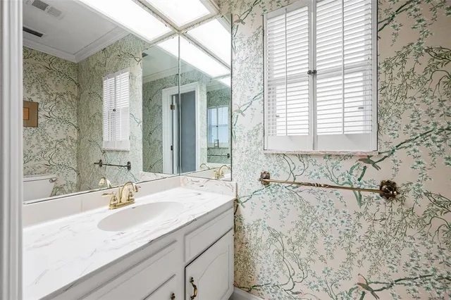 an aerial view of residential house with outdoor space and trees all around