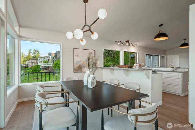 a view of a dining room with furniture wooden floor and chandelier
