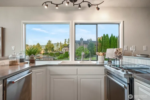 a kitchen with a sink and large window