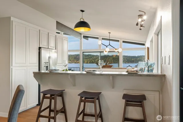 a kitchen with a table chairs sink and cabinets