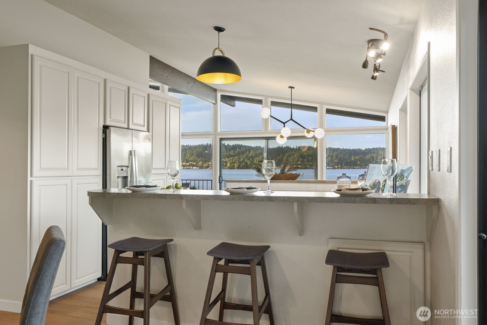 5110 Northwest Sammamish Road Issaquah, WA 98027 - Photo 20 of 40 a kitchen with a table chairs sink and cabinets