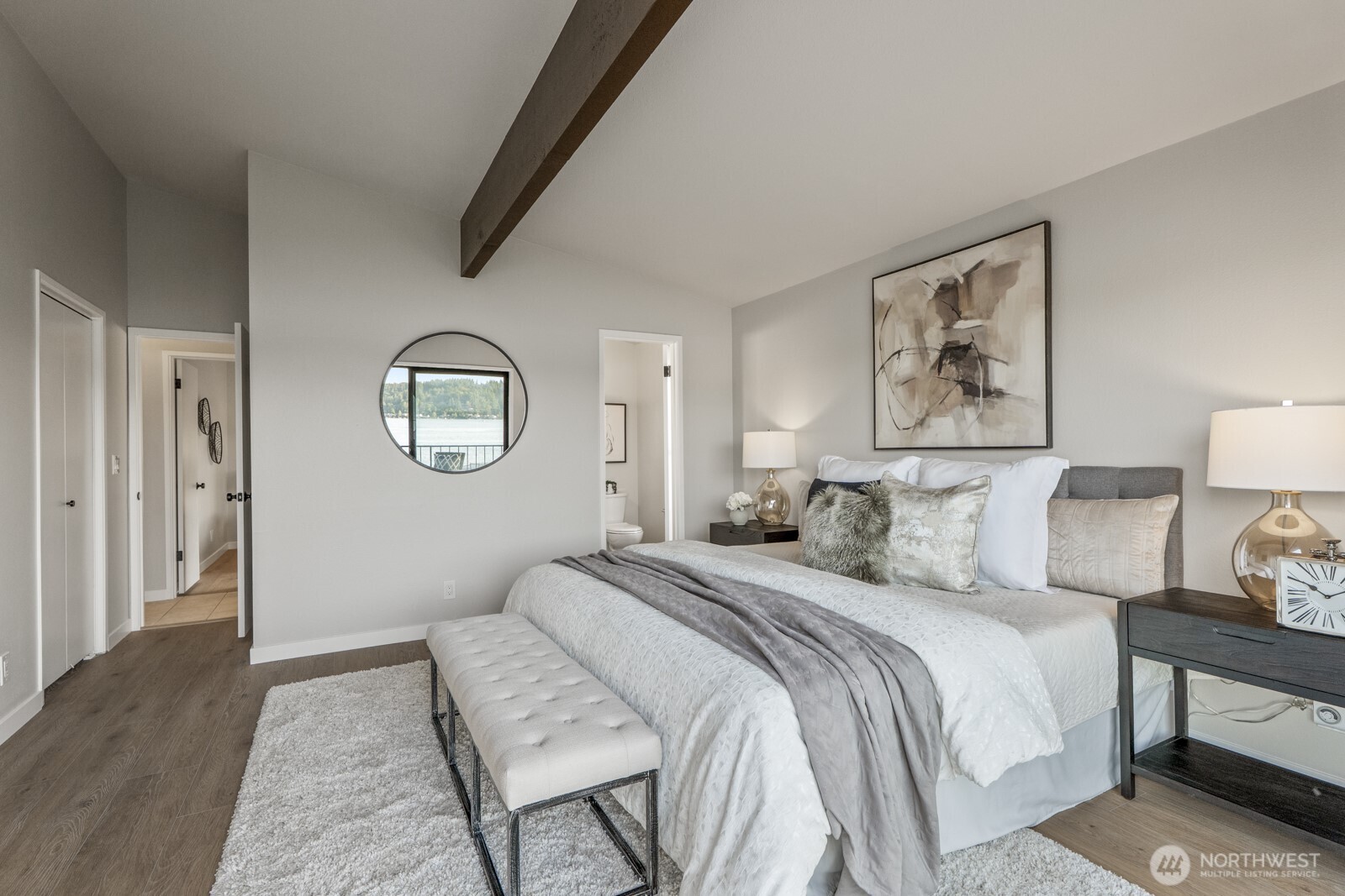 5110 Northwest Sammamish Road Issaquah, WA 98027 - Photo 26 of 40 a bedroom with a large bed and a painting on the wall