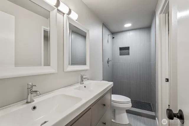 a bathroom with a sink toilet and shower