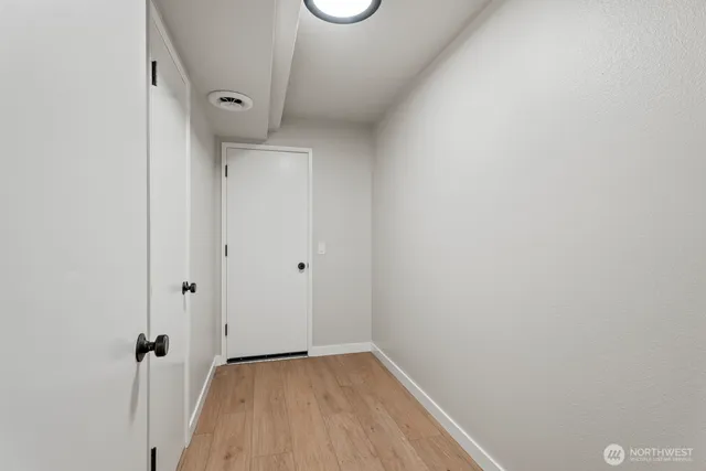 a view of a hallway with wooden floor