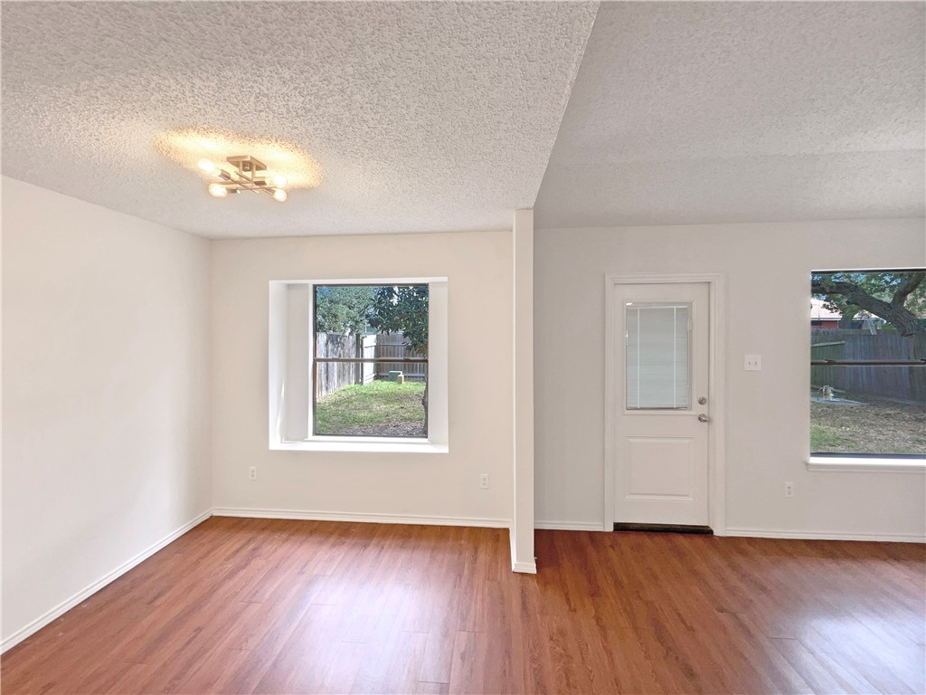 2090 Ridgewood Circle Ingleside, TX 78362 - Photo 12 of 16 an empty room with wooden floor and windows