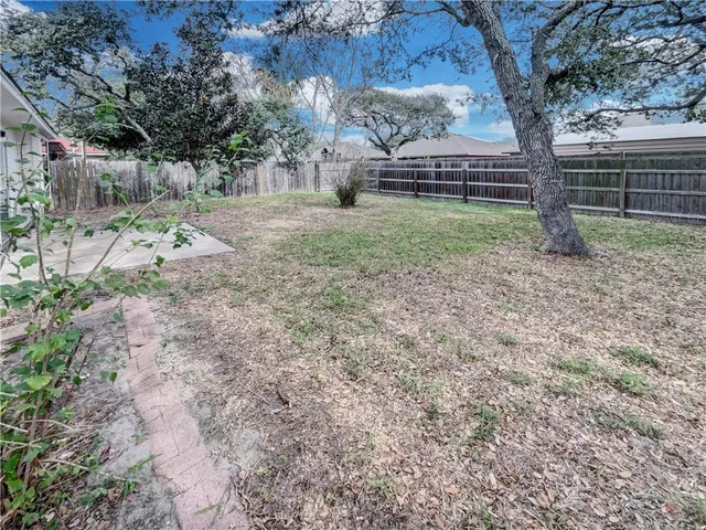 a view of a backyard with large trees