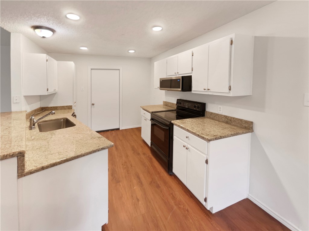 2090 Ridgewood Circle Ingleside, TX 78362 - Photo 2 of 16 a kitchen with stainless steel appliances granite countertop a sink stove and refrigerator