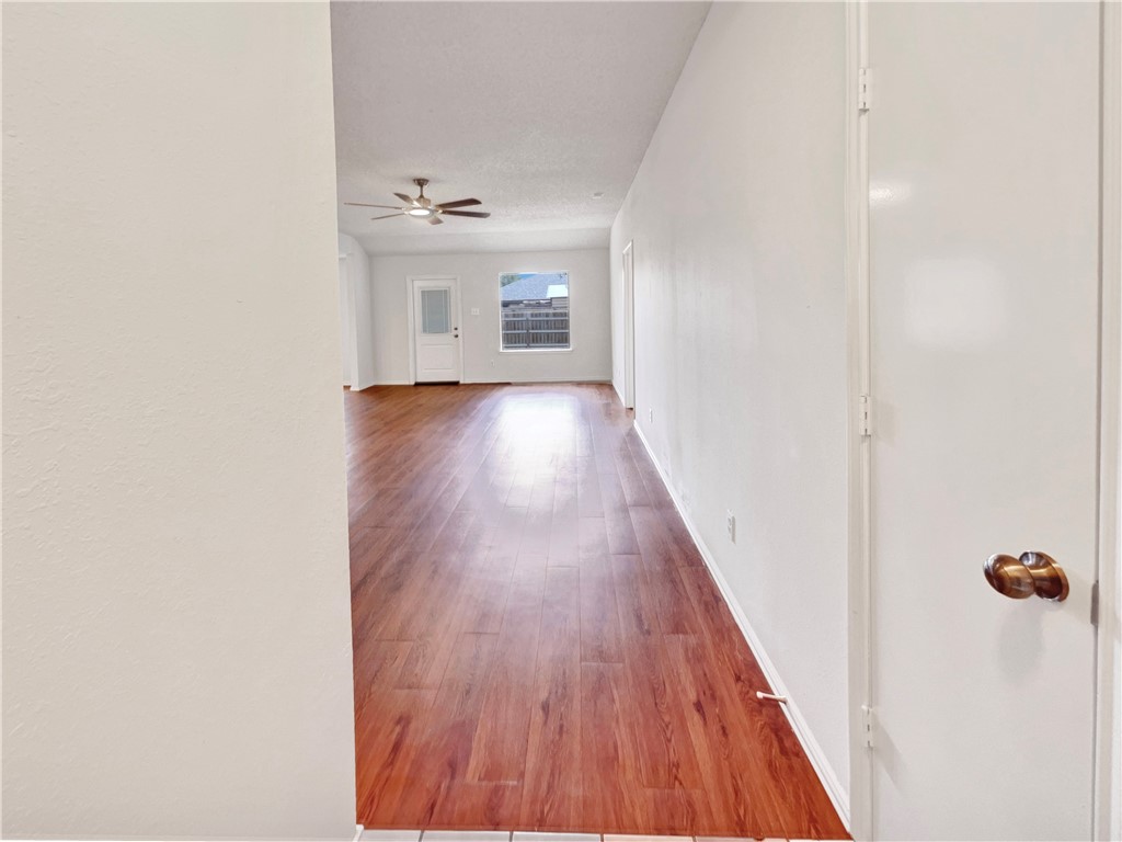 2090 Ridgewood Circle Ingleside, TX 78362 - Photo 6 of 16 a view of a hallway with wooden floor and staircase