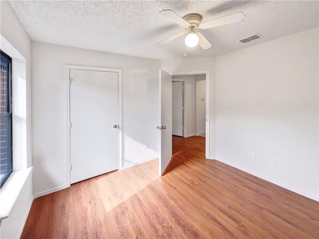 2090 Ridgewood Circle Ingleside, TX 78362 - Photo 8 of 16 wooden floor in an empty room with a window