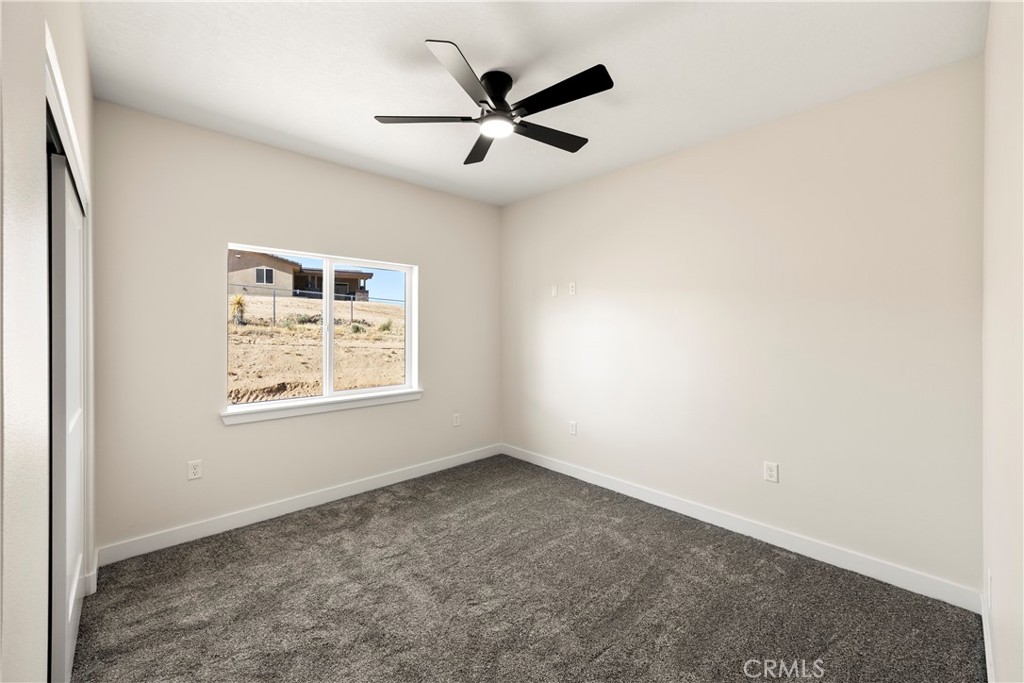 22324 Rancho Street Apple Valley, CA 92308 - Photo 30 of 47 an empty room with ceiling fan and windows