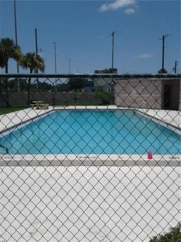 a view of a house with a swimming pool and a yard