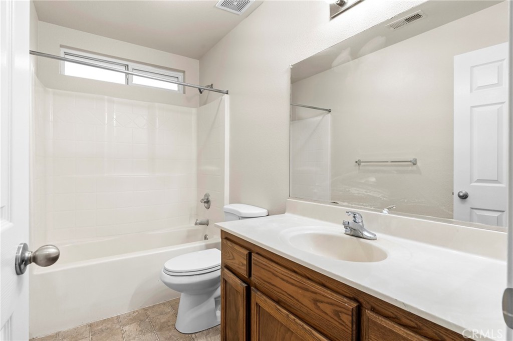 1397 Lucy Way Chico, CA 95973 - Photo 17 of 37 a bathroom with a granite countertop sink toilet a shower and a mirror