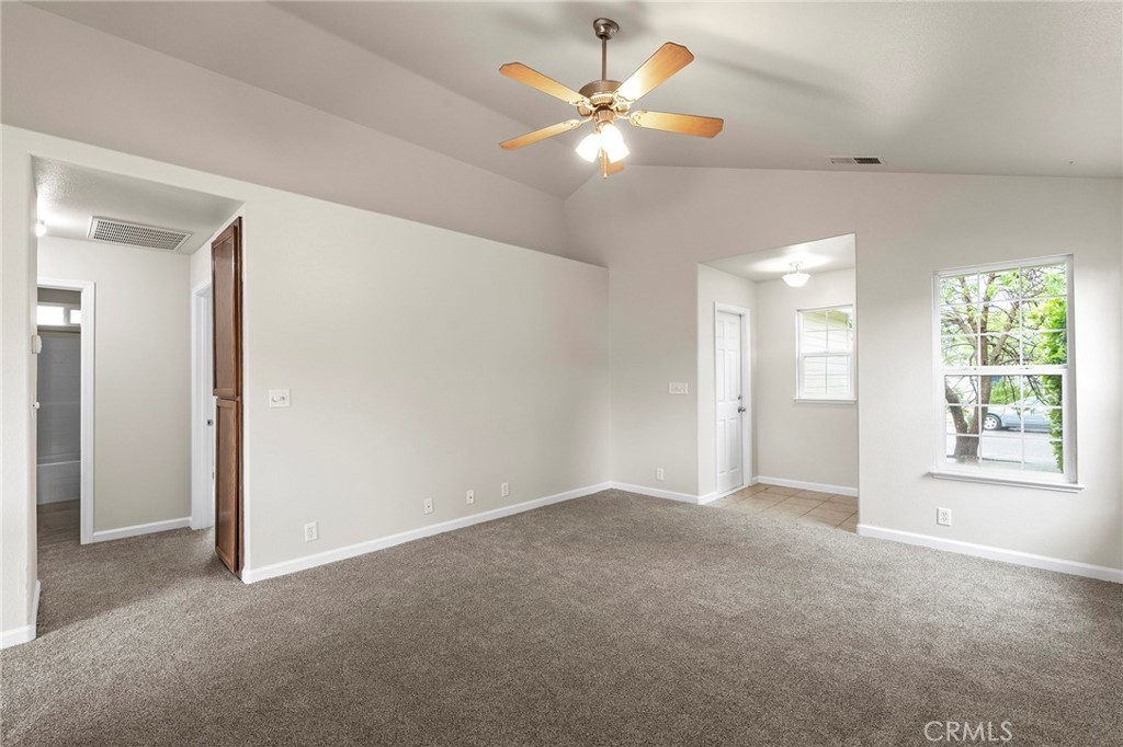 1397 Lucy Way Chico, CA 95973 - Photo 2 of 37 an empty room with chandelier fan and windows