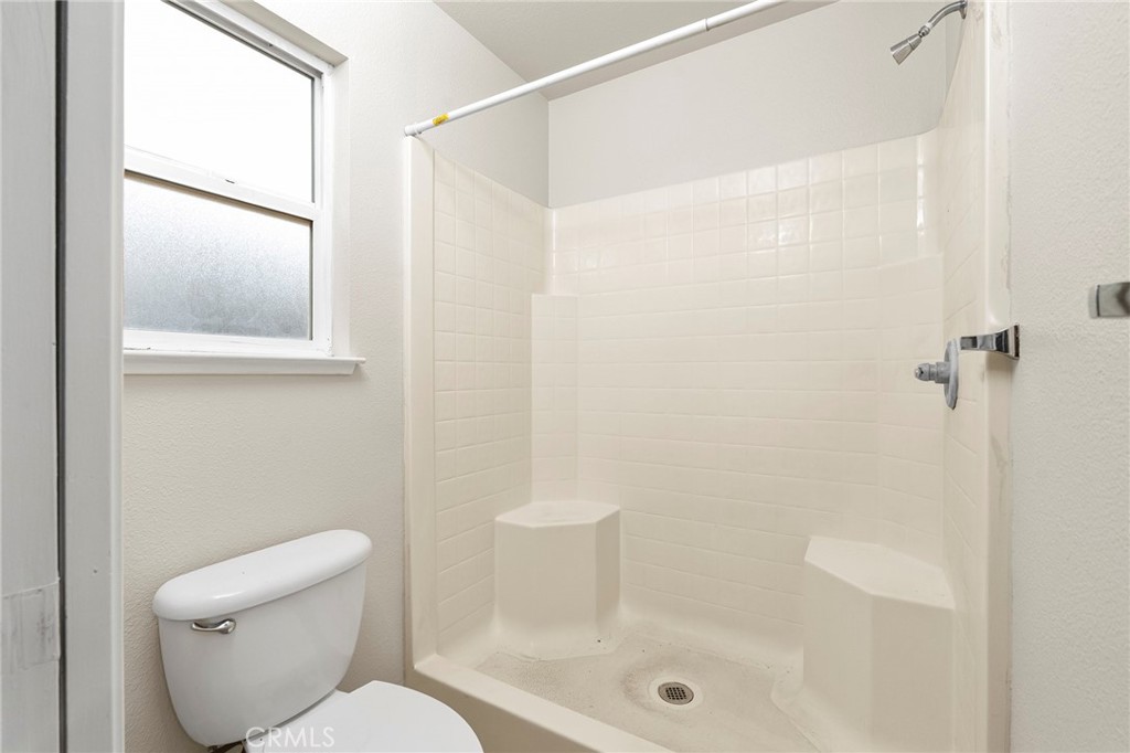 1397 Lucy Way Chico, CA 95973 - Photo 28 of 37 a white toilet sitting next to a bath tub shower