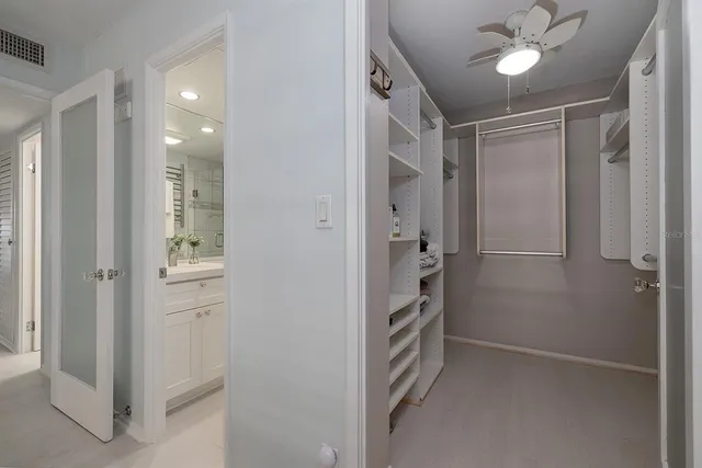 a bathroom with a sink a toilet a glass door a shower and a mirror