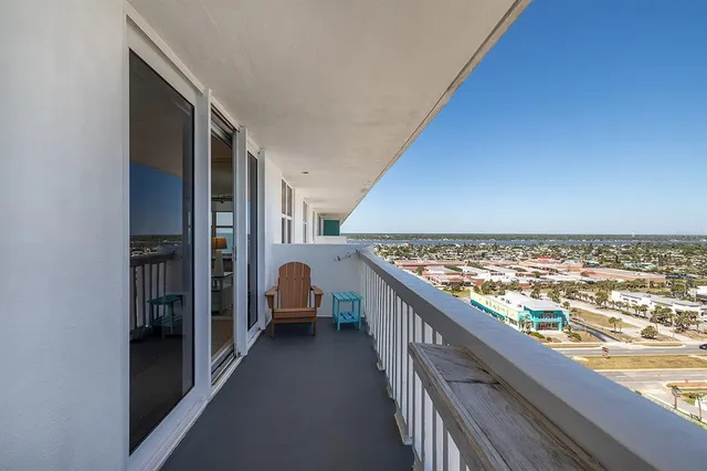 a view of a balcony with chairs