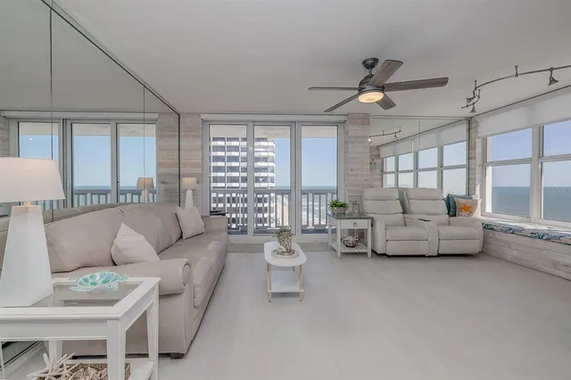 a view of a dining room with furniture and a chandelier fan