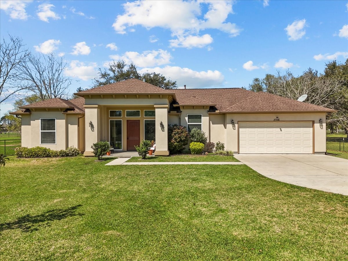 a front view of a house with a garden and porch