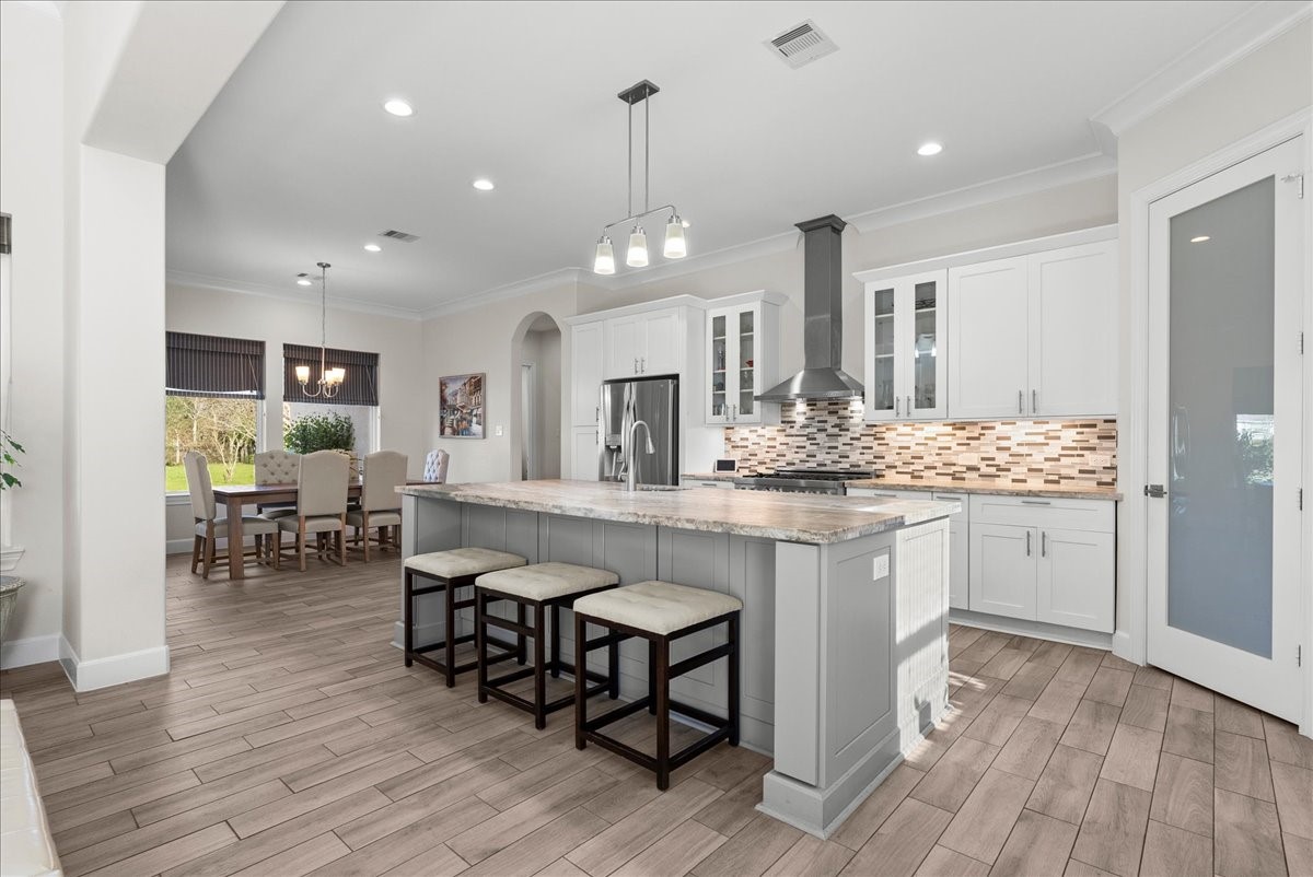 3706 Tower Road Santa Fe, TX 77517 - Photo 16 of 48 a kitchen with counter space dining table and chairs