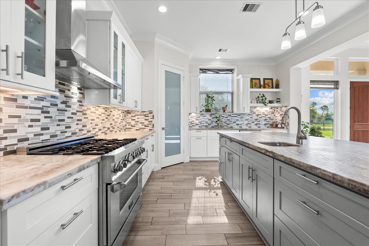 3706 Tower Road Santa Fe, TX 77517 - Photo 19 of 48 a kitchen with stainless steel appliances granite countertop a stove and a sink