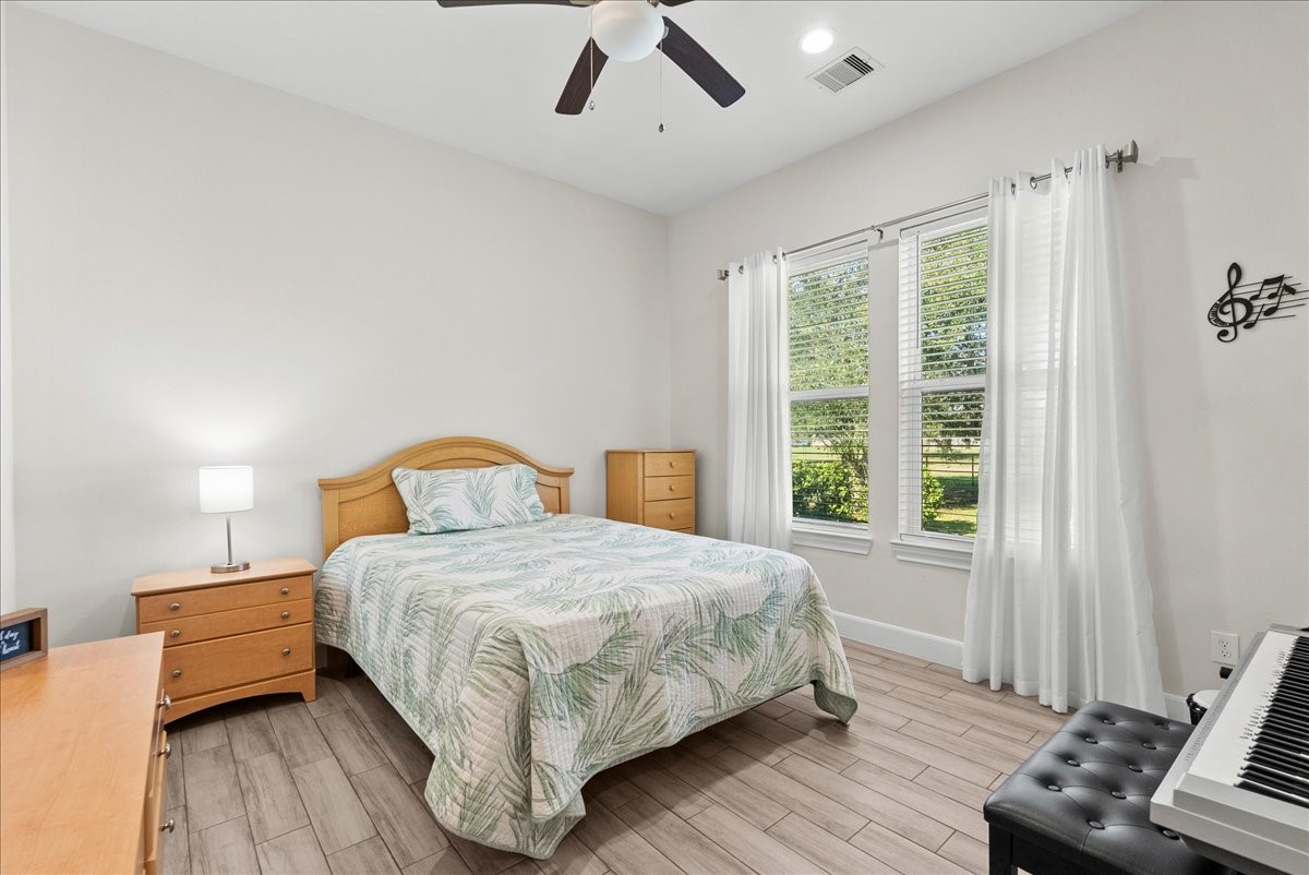 3706 Tower Road Santa Fe, TX 77517 - Photo 32 of 48 a bedroom with a bed and wooden floor