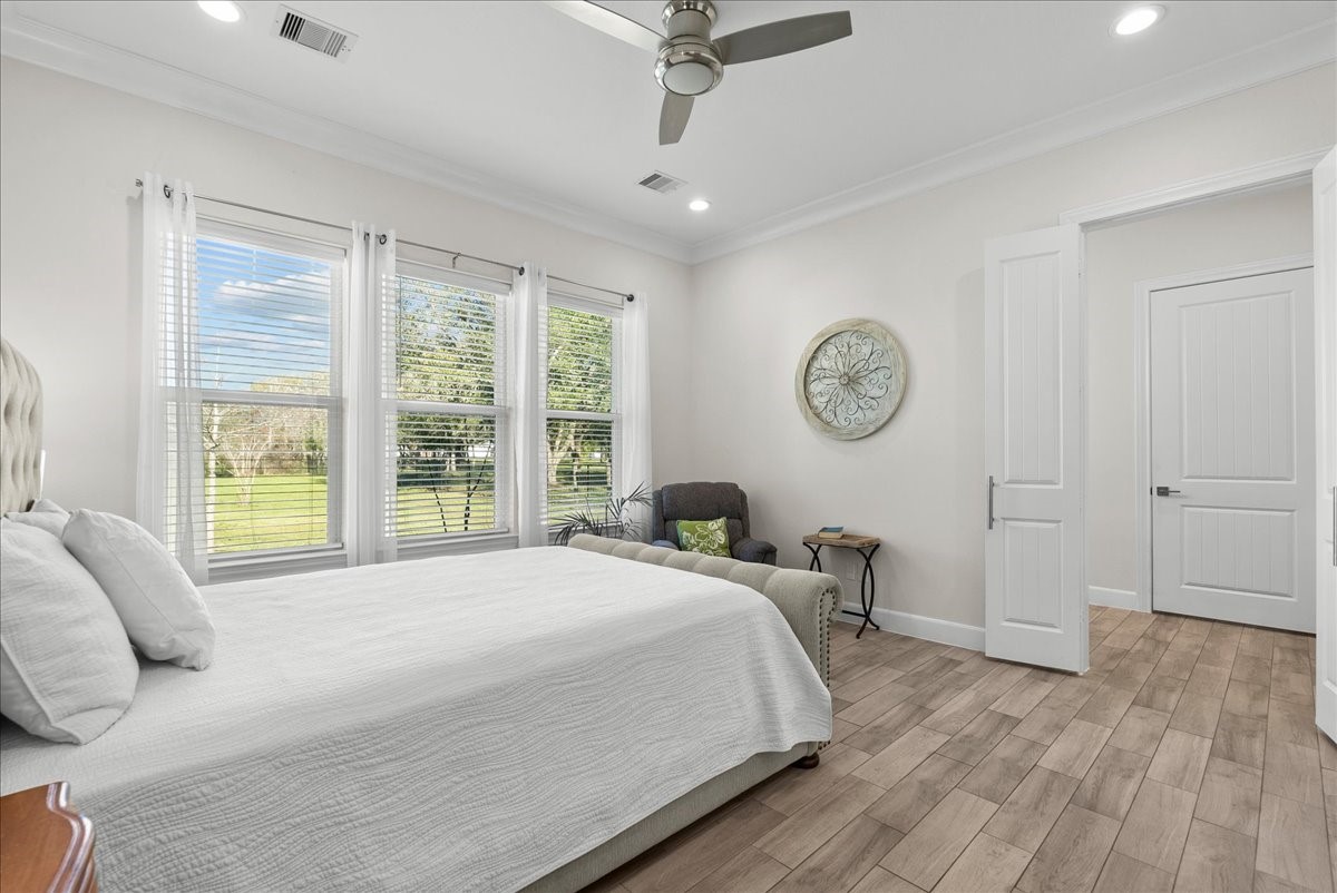 3706 Tower Road Santa Fe, TX 77517 - Photo 35 of 48 a bedroom with a bed large window with a chandelier