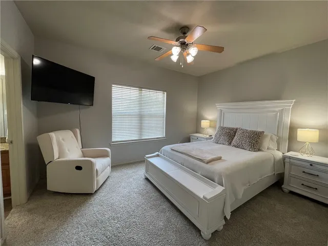 a bedroom with a bed and a chandelier