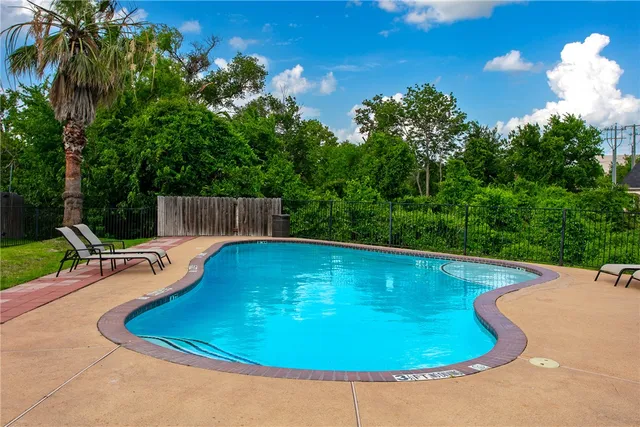a view of a swimming pool with a yard and outdoor seating