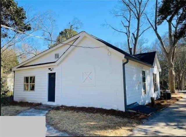 a view of a white house with a yard