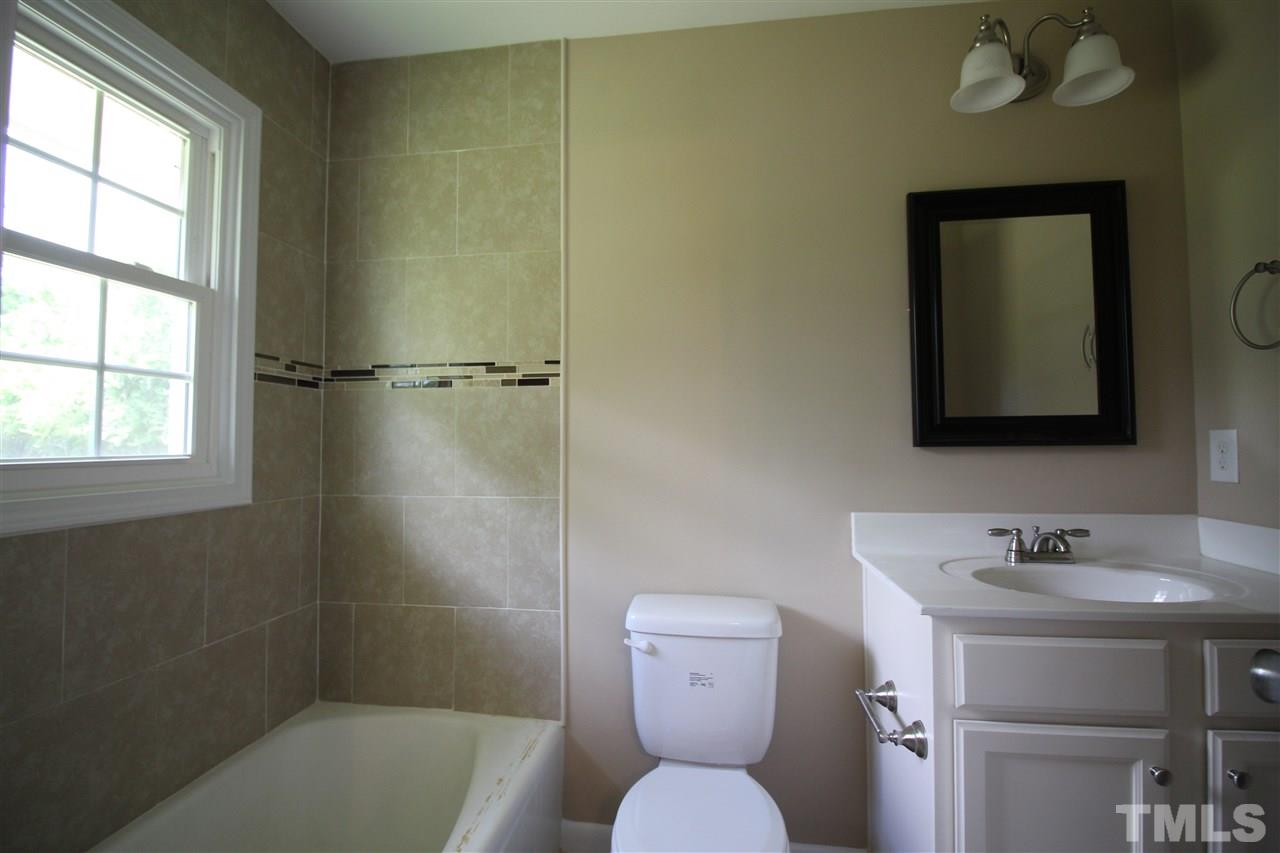 6332 Rock Quarry Road Raleigh, NC 27610 - Photo 14 of 17 a bathroom with a toilet sink and shower