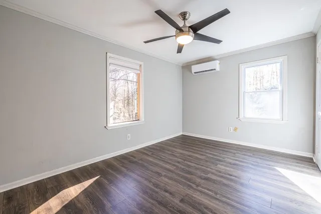 wooden floor in an empty room with a window