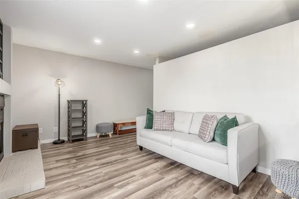 a living room with furniture and a wooden floor