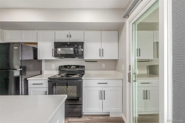 a kitchen with cabinets stainless steel appliances and a counter space