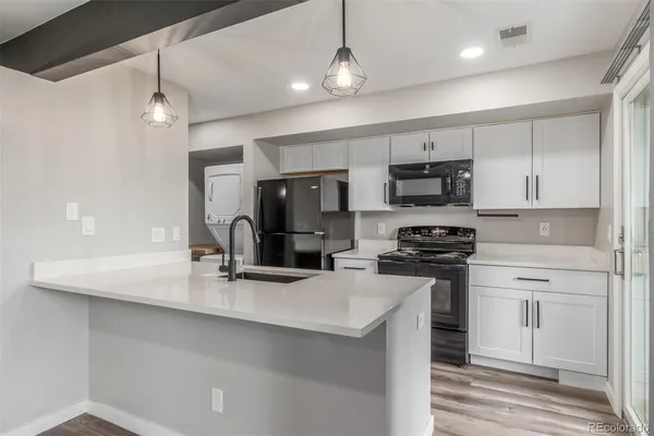 a kitchen with stainless steel appliances a sink stove and refrigerator