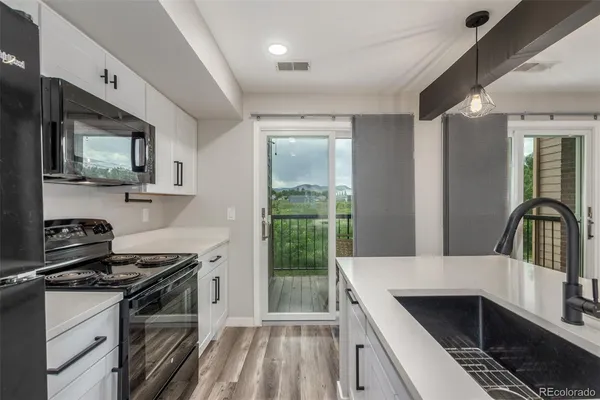 a kitchen that has a sink and a stove