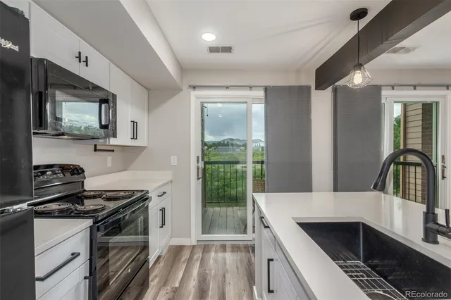 a kitchen that has a sink and a stove