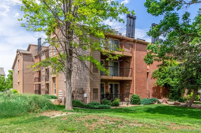 front view of a brick house with a yard