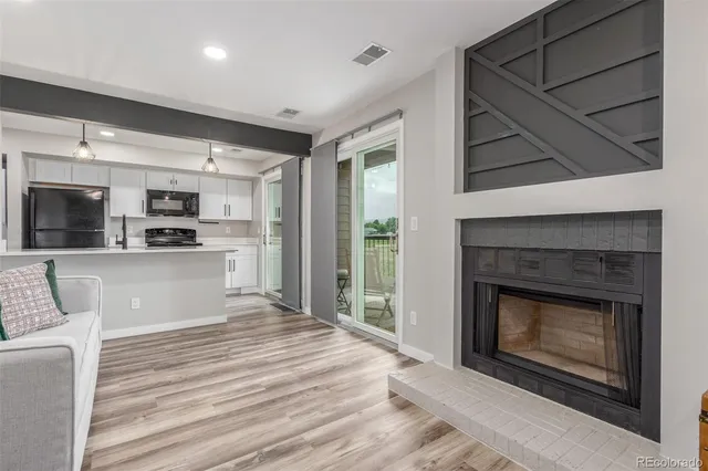 a open kitchen view with fireplace and view living room