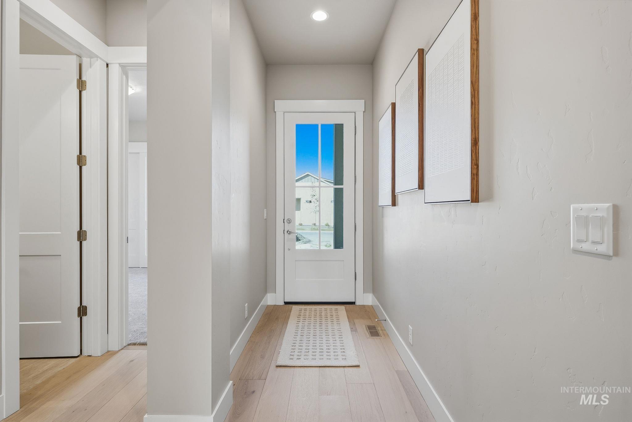 470 South Radiator Way Boise, ID 83716 - Photo 3 of 50 Entryway featuring a glass-paneled door, light wood-finish flooring, recessed lighting, and crisp white trim