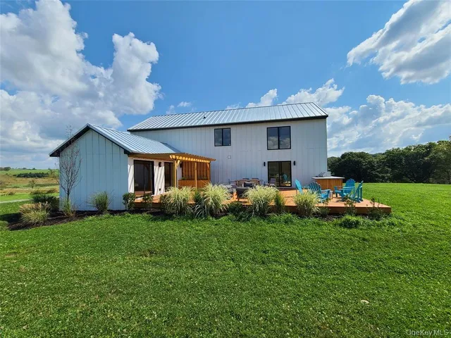 a front view of house with yard and outdoor seating