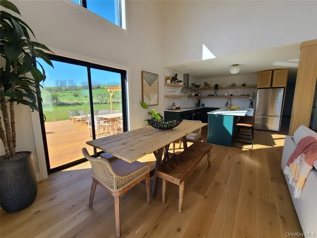 a view of a dining room with furniture window and wooden floor