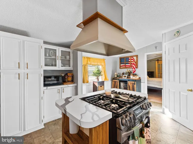 a kitchen with stainless steel appliances stove top oven and refrigerator
