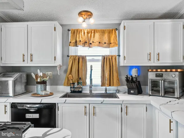 a kitchen with a sink cabinets and window